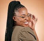 Happy black woman, face and holding glasses with smile, vision and excited, prescription lens isolated on studio background. Eyewear, eye care and healthcare for eyes, fashion frame and optometry