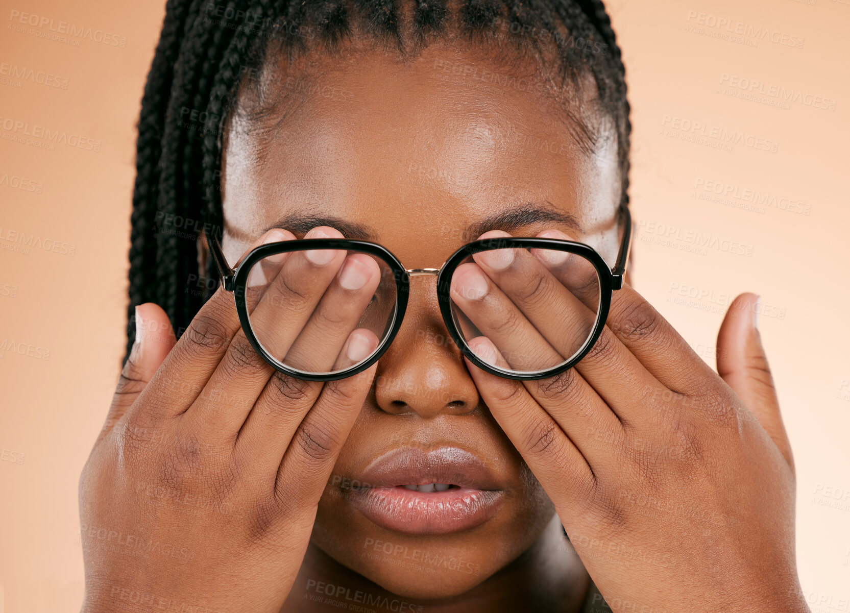 Buy stock photo Hands, eye health or glasses with a black woman in studio on a beige background covering her face. Vision, blind and cover with a female indoor to promote eyecare in the optometry or optical industry