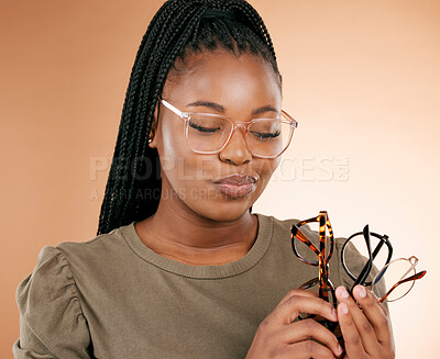 Buy stock photo Woman, studio and choose glasses for eye health, vision or thinking with excited happiness. African model, choice and fashion spectacles for decision, optometry wellness or frame design by background