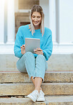 Woman, student and smile with tablet on stairs for social media, browsing or research relaxing at the campus. Happy female learner smiling for streaming entertainment or 5G connection on touchscreen