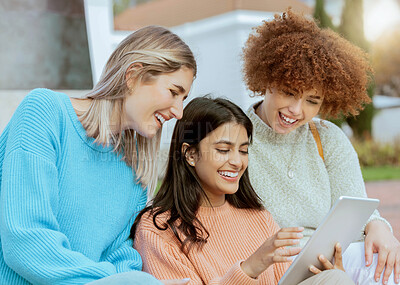 Buy stock photo Student, friends and tablet laughing for meme, social media or streaming online entertainment at campus. Happy women sharing laugh for funny joke, chat or post on touchscreen together at university
