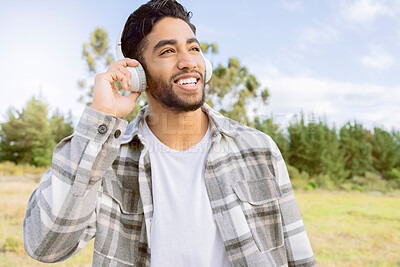 Buy stock photo Music, smile and man with headphones in forest, happy and relax on blue sky, tree and space background. Radio, earphones and guy, smile and joy while listening to audio, podcast or track in forest