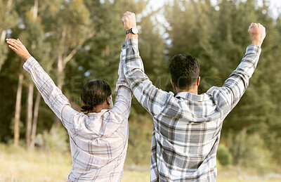 Buy stock photo Behind, hiking and couple holding hands for success in forest for achievement, victory or fitness goals. Travel, freedom and man with woman celebrating milestone, journey and adventure goal in nature