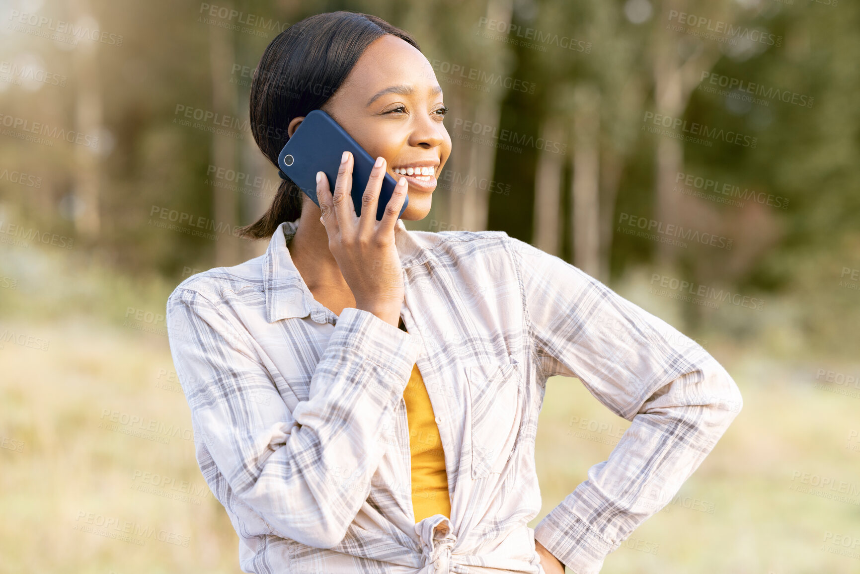 Buy stock photo Black woman, forest and phone call for talking, thinking and smile on grass in summer sunshine. Adventure holiday, comic smartphone conversation or funny talk for girl for networking, woods and joke