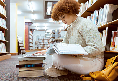 Buy stock photo College learning, library and book reading with laptop of a black woman student on the ground. Education research, bookshelf and books of a young female looking studying for a school test or exam