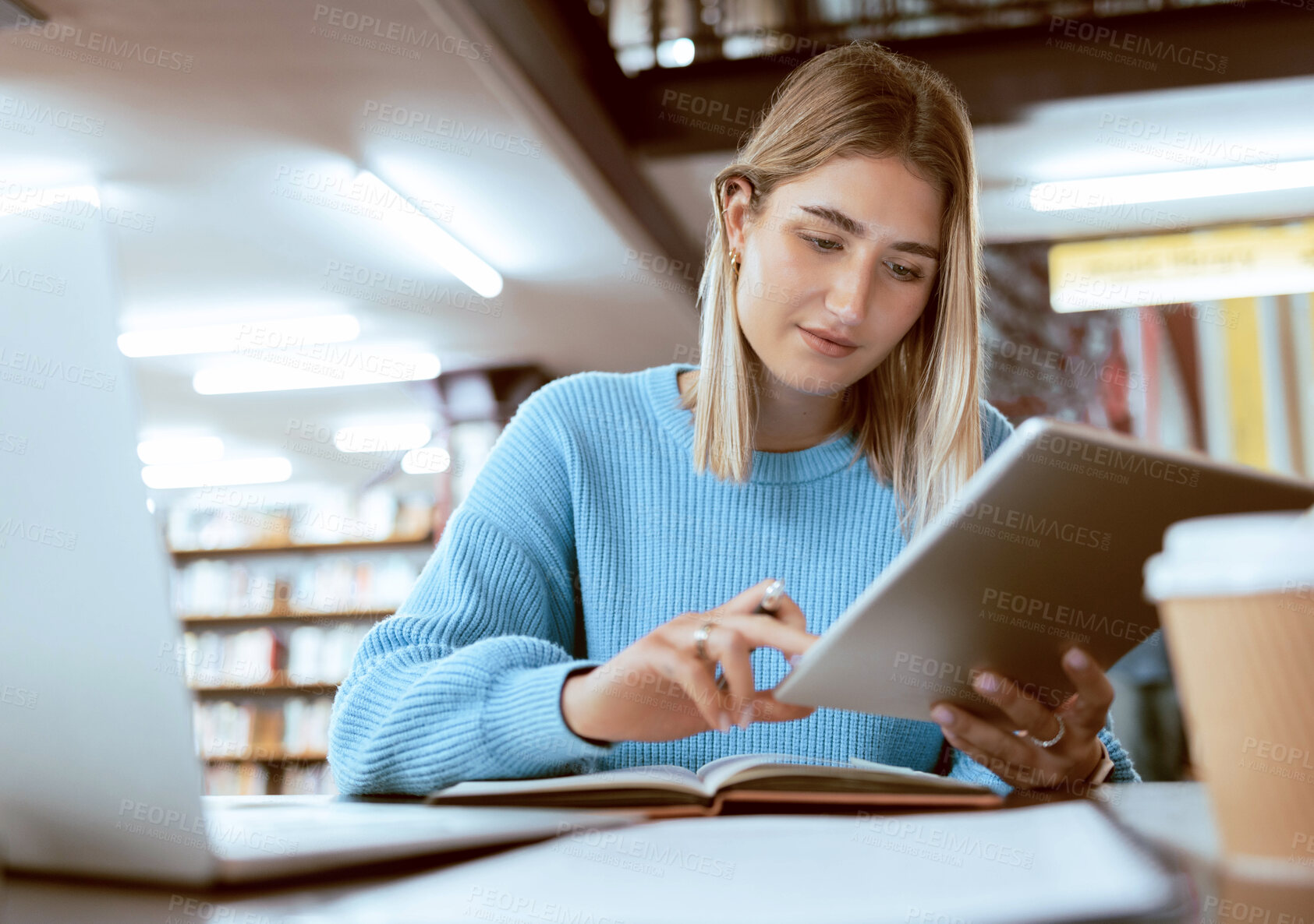 Buy stock photo Education, university and woman in library with tablet, research and books for school project or exam. Laptop, notebook and internet, college student studying with technology and elearning on campus.