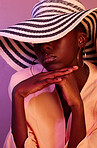 Fashion, sun hat and black woman in a studio with neon light for aesthetic with beauty and trend. Stylish summer accessory, UV and young African female model with style by a purple background.