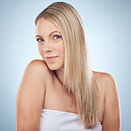 Skincare, beauty and portrait of a woman with hair care isolated on a blue background in a studio. Spa, wellness and  cosmetology model with facial makeup, cosmetics and dermatology on a backdrop