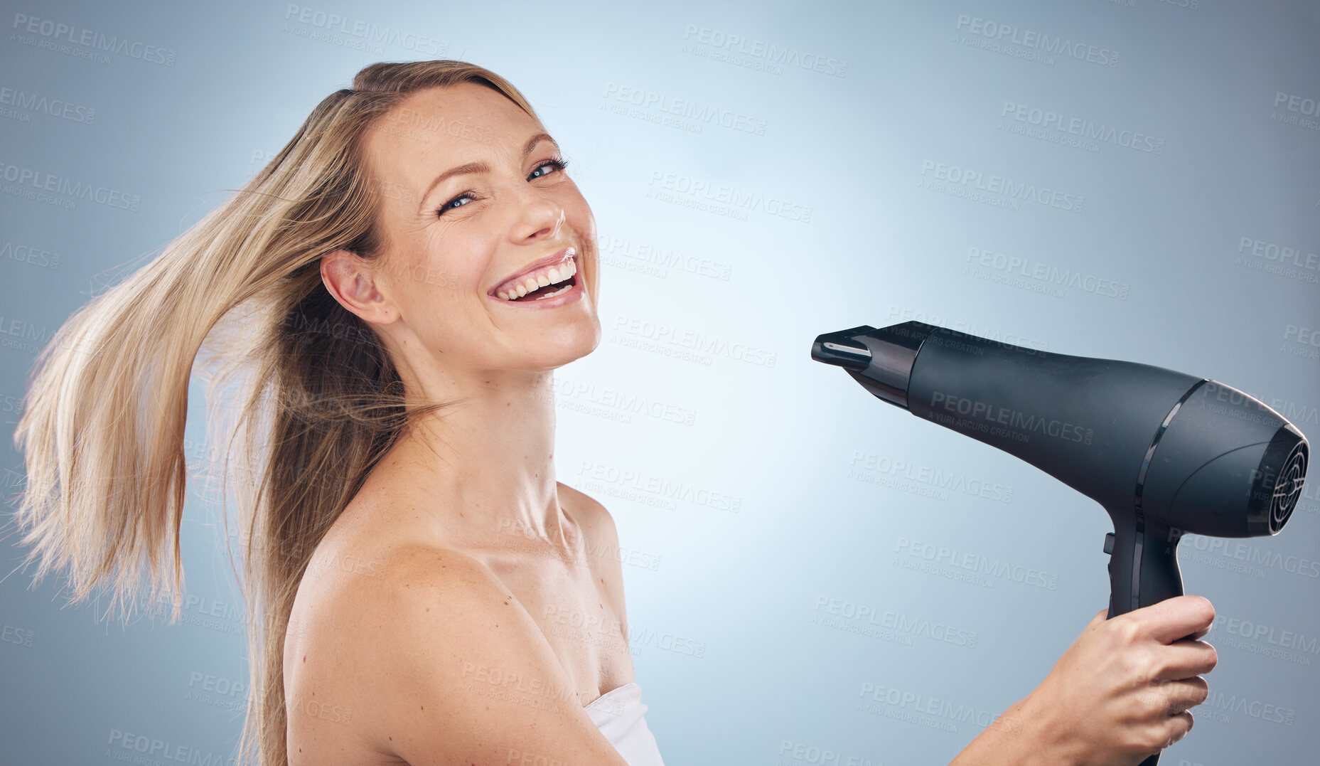 Buy stock photo Face, hair dryer and beauty portrait of woman in studio isolated on a gray background. Balayage, haircare and happy female model with hairdryer product for hairstyle, grooming or salon treatment.
