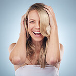 Face portrait, hair care and beauty of woman in studio isolated on a gray background. Keratin, cosmetics and laughing female model with blonde hairstyle after salon treatment for growth or texture.
