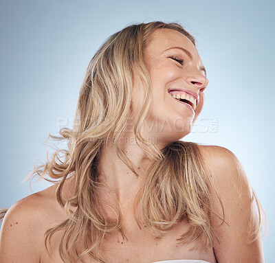 Buy stock photo Beauty, skincare and laughter with a model woman in studio on a gray background enjoying a joke or humor. Facial, cosmetics and funny with an attractive young female laughing for natural treatment