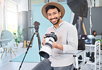 Portrait, photographer and man with camera in studio, happy and smile before a photo shoot. Face, photography and asian guy relax during professional, shooting for model, design and creative career