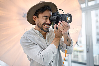 Buy stock photo Photography, studio and camera with a man photographer taking a picture backstage during a photoshoot. Creative, light and production with a male using a photographic lens to take a photograph