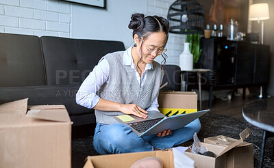 Buy stock photo Planning, real estate and woman with a laptop while moving for apartment email and online contract. Mortgage, boxes and Asian girl typing on a computer for a relocation property idea in the lounge