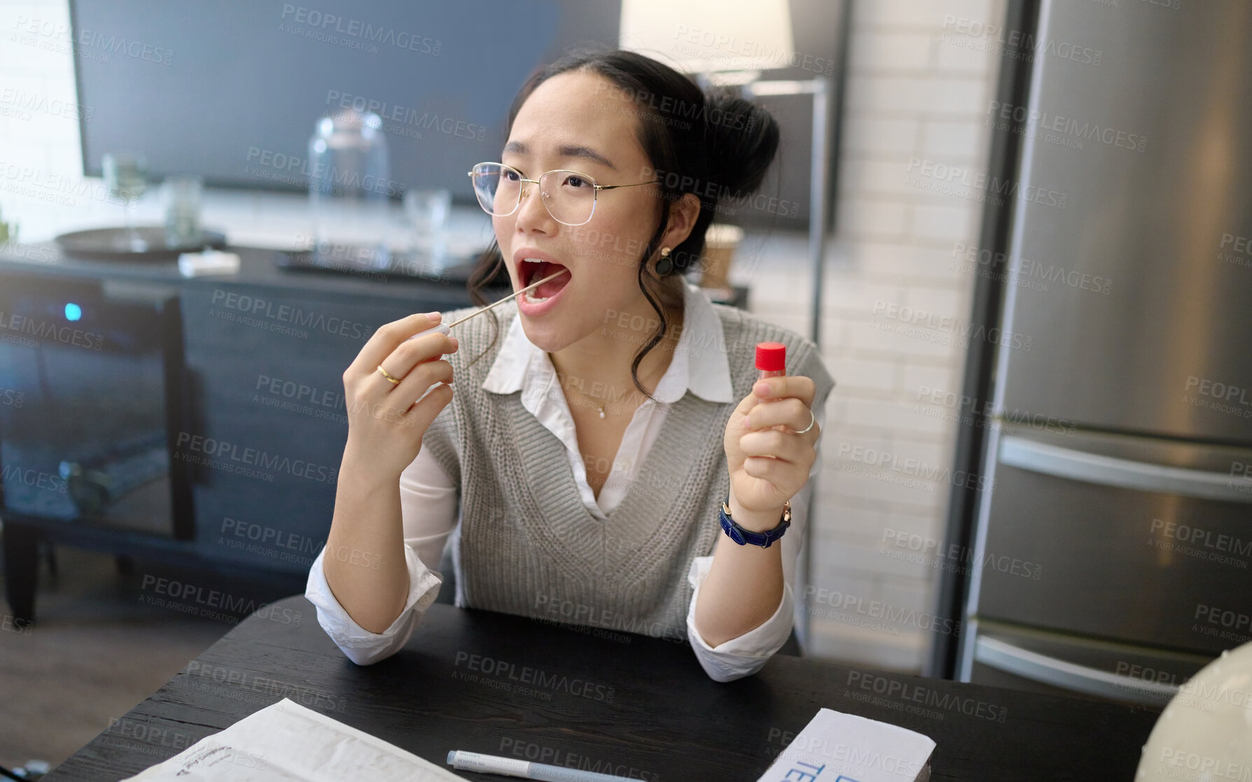 Buy stock photo Covid test, mouth and pcr exam with Asian woman medical and healthcare testing with cotton swab. Disease, virus and health check of a young person in a home kitchen looking for corona results 