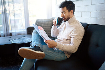 Buy stock photo Relax and reading newspaper by man with coffee or drinking tea in a home, house or apartment on weekend. Mexican, news and young person enjoying free time with an article, story or paper