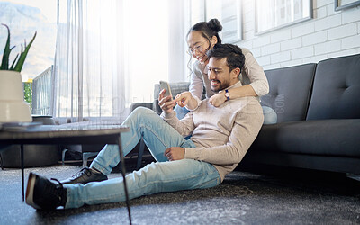 Buy stock photo Interracial, couple and people with phone on social media laughing at meme or funny internet content. Man, woman and lovers relax in home, house or apartment browsing the web, website or app
