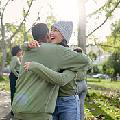 Hug, friends and happy volunteer people outdoor at nature park with ...
