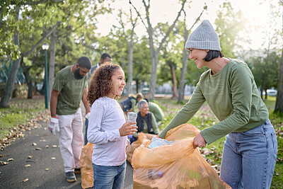 Buy stock photo Trash volunteer, happy woman and child cleaning garbage, pollution or waste product for community environment support. Plastic bag container, NGO charity and nature park clean up by eco friendly kid