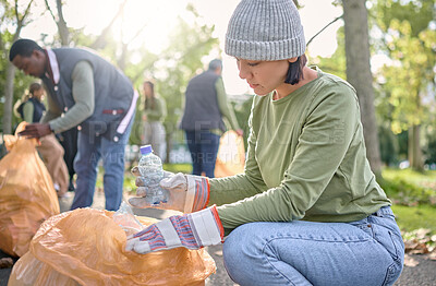 Buy stock photo Trash, community volunteer and woman cleaning garbage pollution, waste product or team environment support. Plastic bottle container, NGO charity or eco friendly people help with nature park clean up