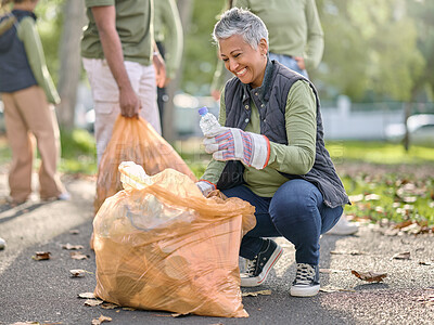 Buy stock photo Trash, volunteer and elderly woman cleaning garbage, pollution or waste product for environment support. Plastic bag container, NGO charity and eco friendly community help with nature park clean up