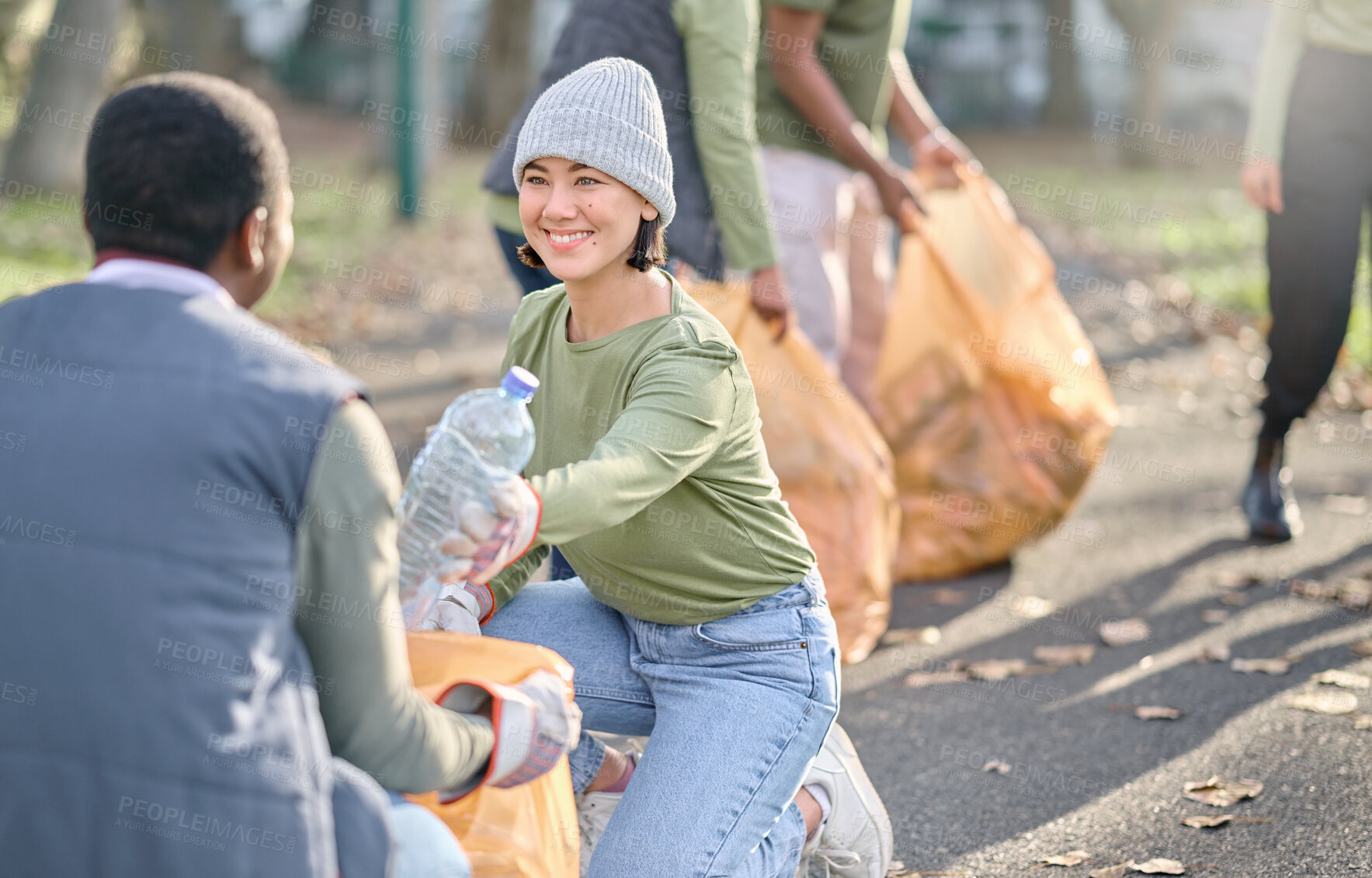 Buy stock photo Volunteer, community service and people cleaning plastic in park with garbage bag. Happy woman and man team help with trash for eco friendly lifestyle and recycling in nature for a clean enviroment