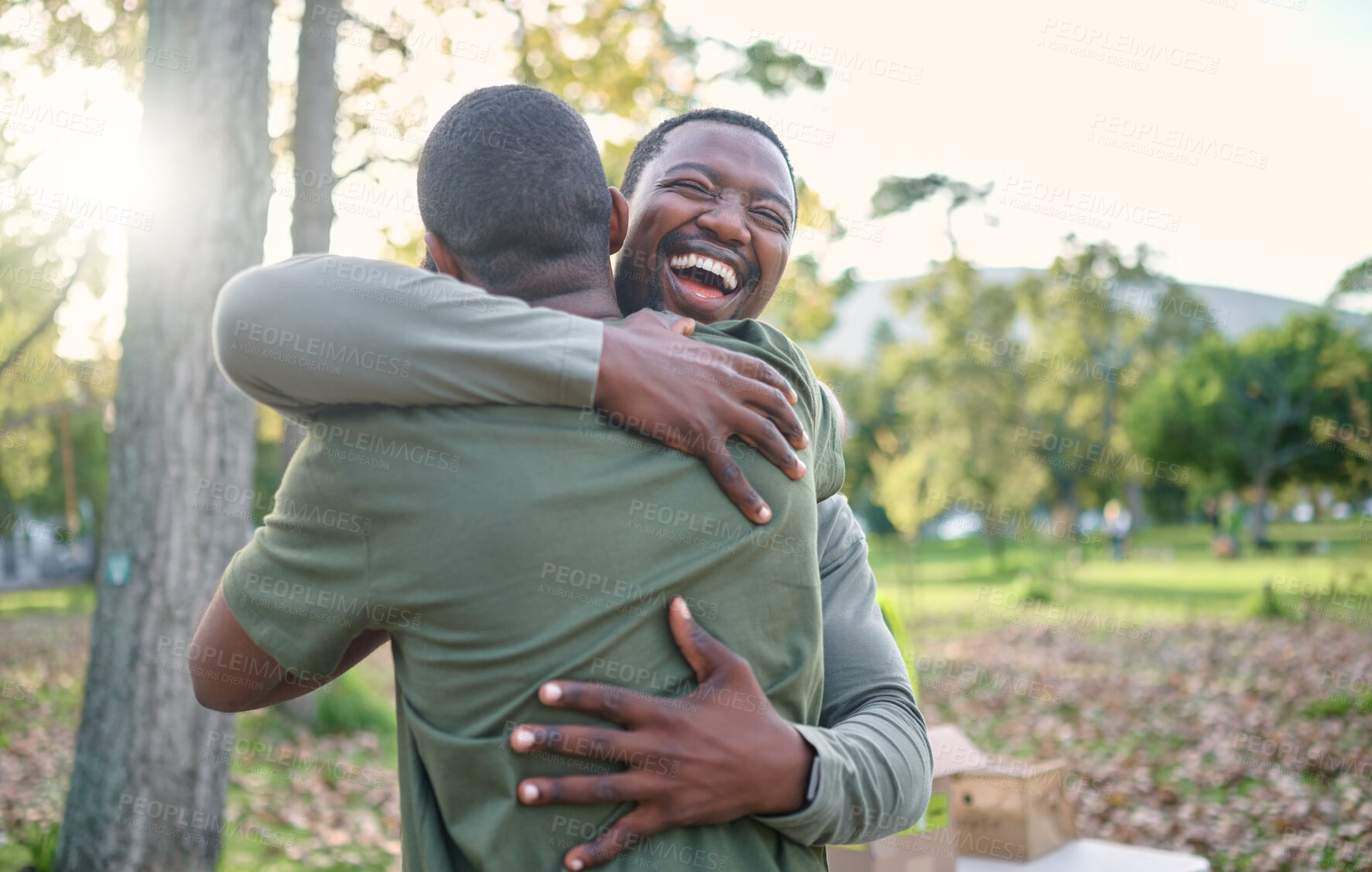 Buy stock photo Charity, happy and hug with volunteer friends in a park for community, charity or donation of time together. Support, teamwork or sustainability with a black man and friend hugging outdoor in nature