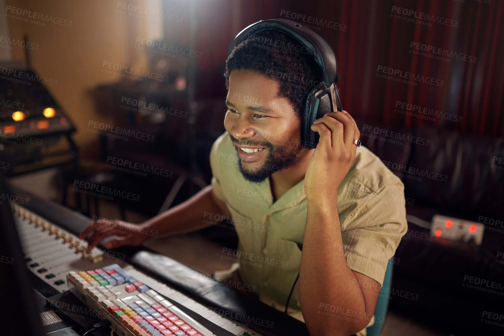 Buy stock photo Headphones, studio and male music producer working a album, song or audio with tech equipment. Happy, smile and black man radio presenter playing a playlist with technology in his creative workplace.