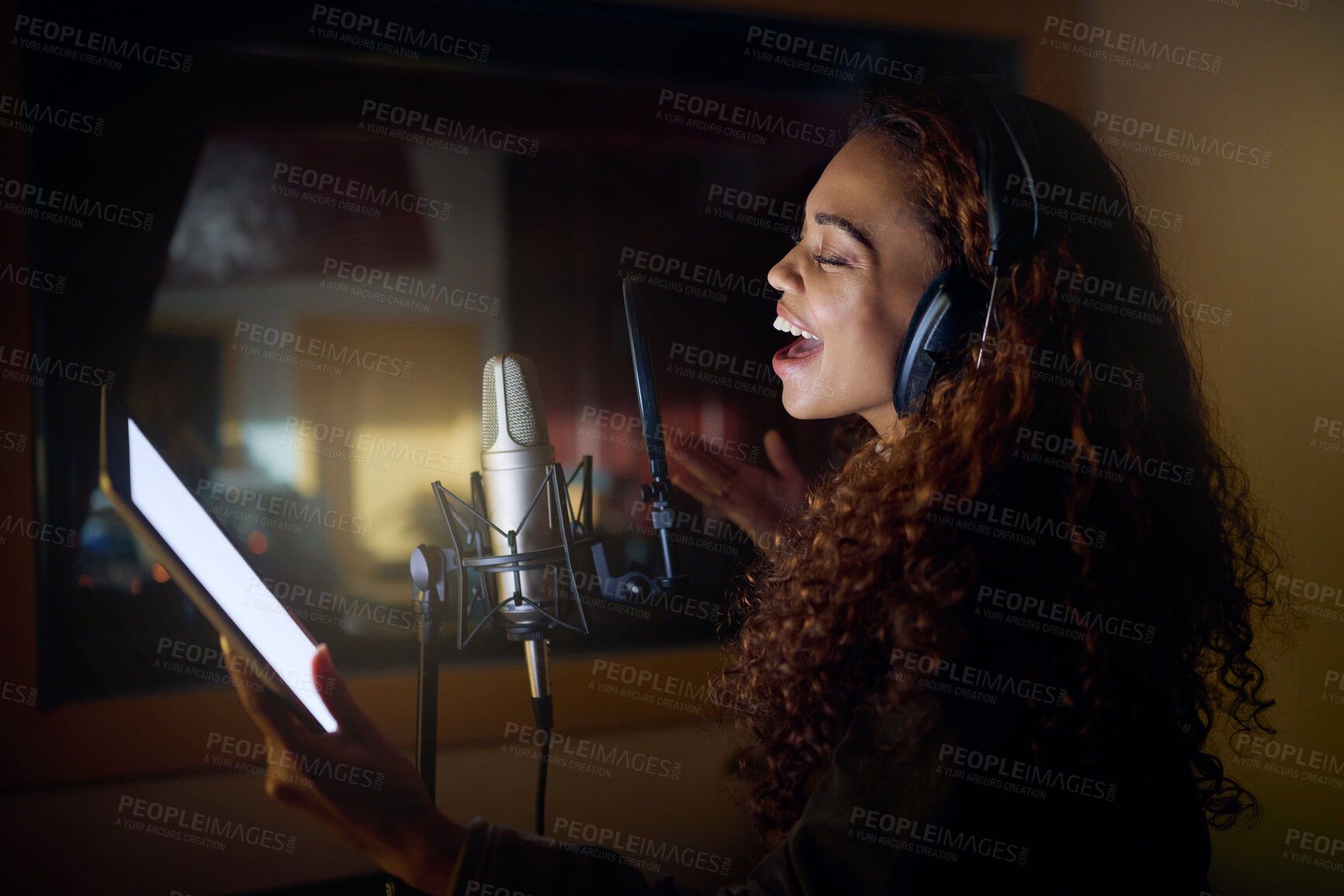 Buy stock photo Tablet, singing or musician on studio microphone, mockup music or mock up lyrics in night recording. Singer, woman or artist on technology in production app, voice media or sound performance practice