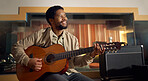 Musician, acoustic and man playing the guitar for music production or recording in studio. Artist, guitarist and African guy strumming the strings of a musical instrument for sound track performance.