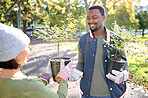 Teamwork, gardening and man with woman in a park happy and smiling for plant growth for sustainability in the environment. Volunteer, black man and people excited for planting as in a garden