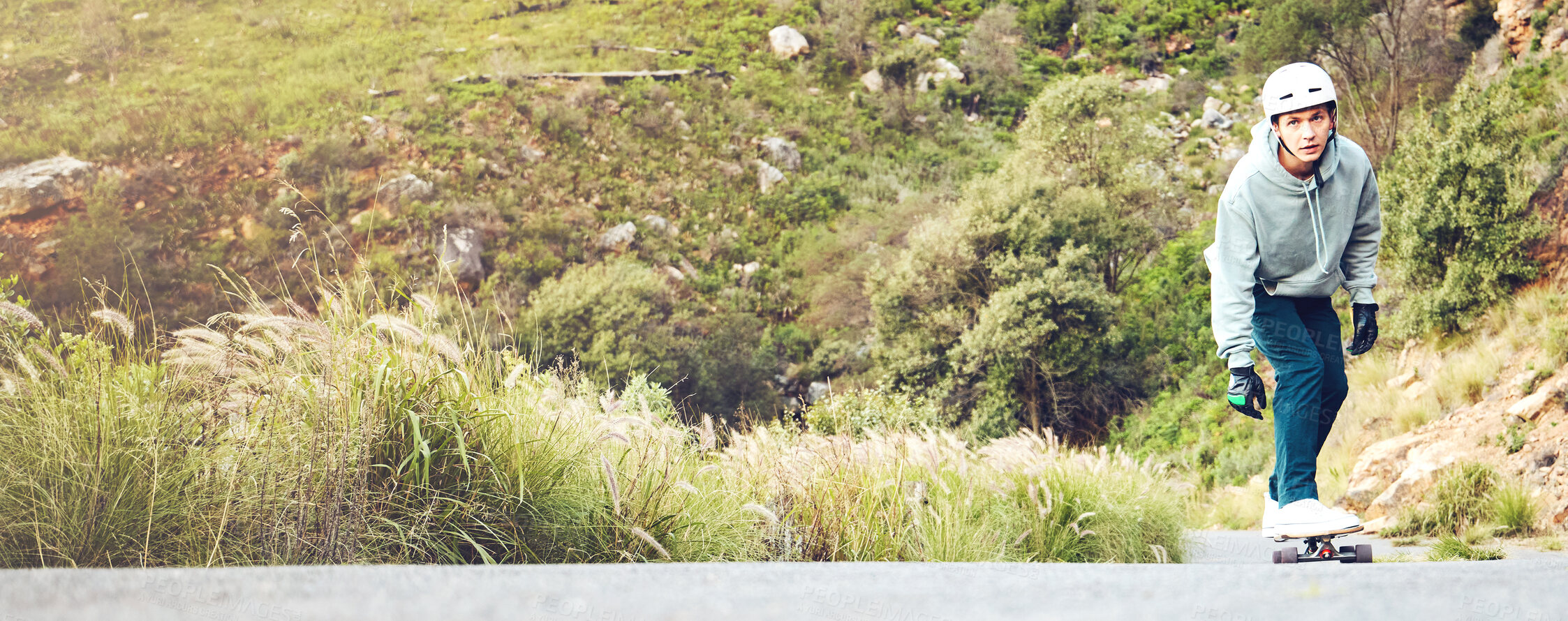 Buy stock photo Skateboard, nature and mockup with a sports man on an asphalt street skating through the mountains. Skater, green and mock up with a male athlete skateboarding on a road alone in the wilderness