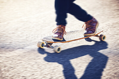 Feet, skateboard and man skating on road for fitness, exercise and wellness. Training sports, shoes and legs of male skater on board, skateboarding or riding outdoors for balance or workout on street