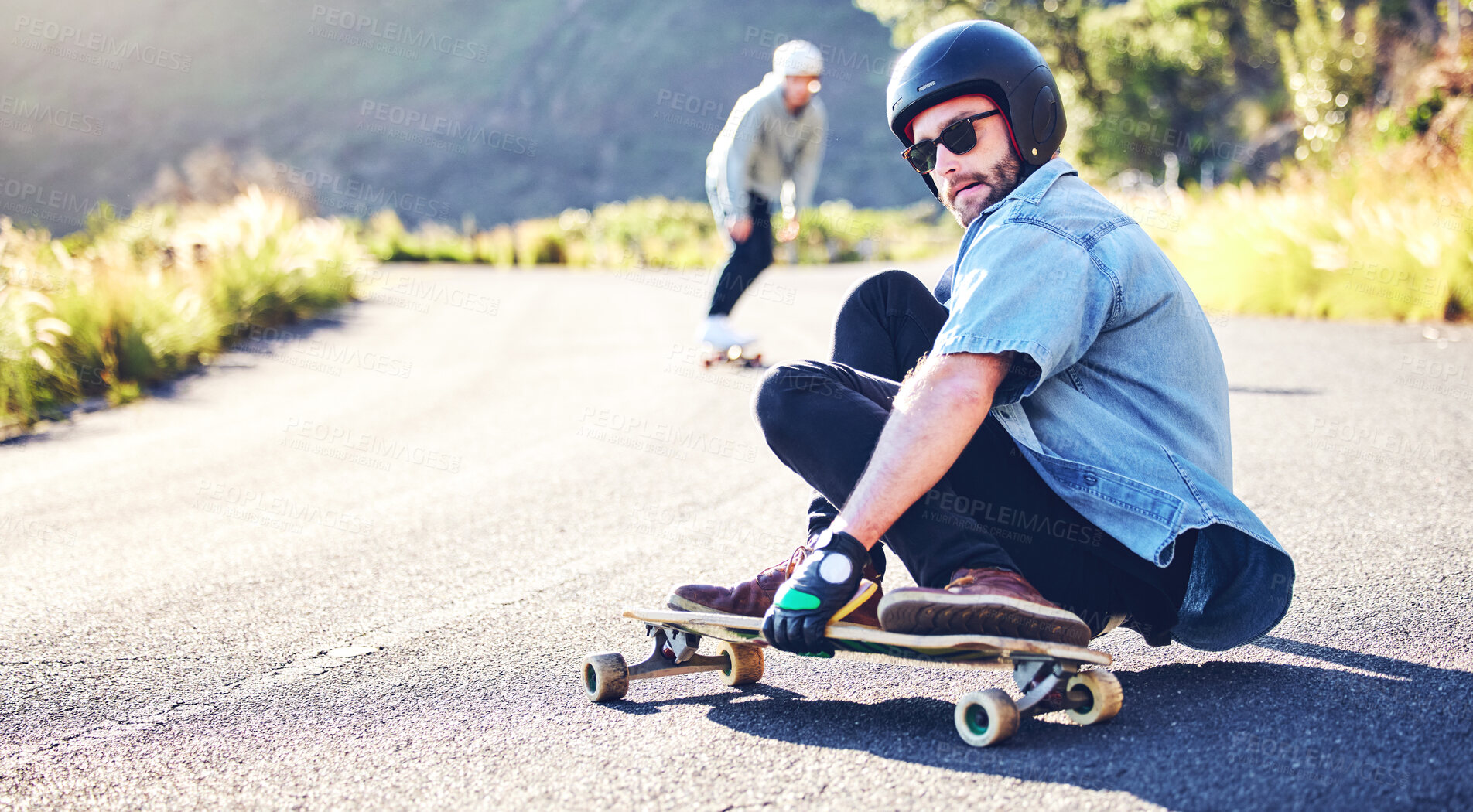 Buy stock photo Road, skateboard sports and man skating for fitness, exercise and wellness. Training, sunglasses and male skater sitting on board, skateboarding and riding for action stunt, exercising or workout.