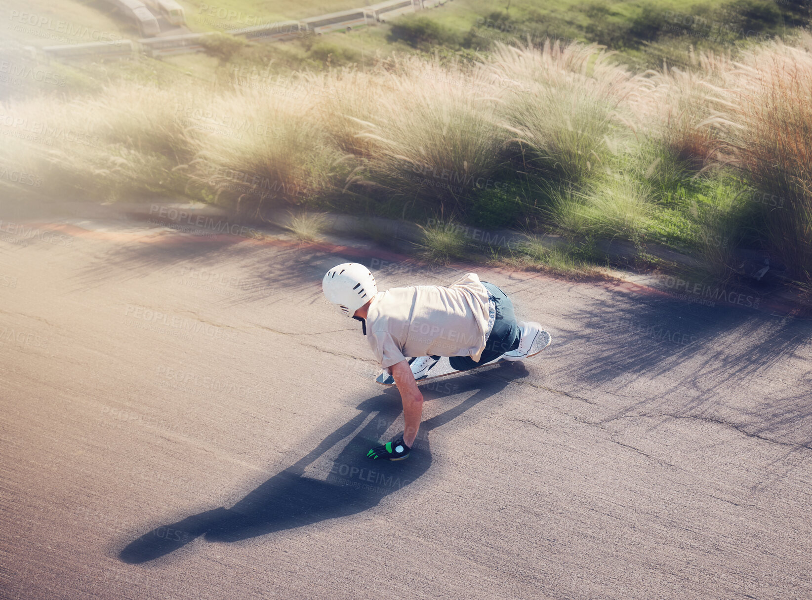 Buy stock photo Skate, blurred motion and fast with a sports man skating on an asphalt road outdoor from the back. Skateboard, soft focus and speed with a male athlete or skater training outside on the street