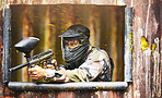Paintball, gun and camouflage with a sports man playing a military game for fun or training outdoor. War, soldier and target with a male athlete shooting a weapon outside during an army exercise