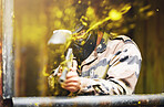 Paintball, soldier and camouflage with a sports man playing a military game for fun or training outdoor. War, gun and target with a male athlete shooting a weapon outside during an army exercise