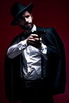 Assassin, suit or shooting gun on studio background in dark secret spy, isolated mafia leadership or crime security. Model, gangster or hitman weapon in aim, formal style or fashion clothes aesthetic