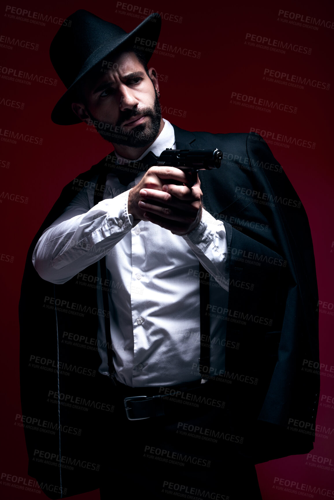 Buy stock photo Assassin, suit or shooting gun on studio background in dark secret spy, isolated mafia leadership or crime security. Model, gangster or hitman weapon in aim, formal style or fashion clothes aesthetic