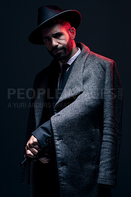Buy stock photo Gangster, portrait and holding gun on studio background in dark secret spy, isolated mafia leadership or crime lord security. Model, man and hitman suit weapon in formal or fashion clothes aesthetic