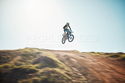 Buy stock photo Motorbike, cycling and jump on blue sky mockup for speed challenge, sports and fearless athlete. Driver, air stunt and driving over hill with adrenaline, competition adventure and motorcycle power 