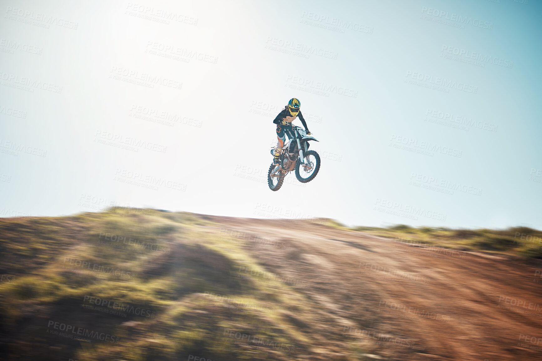 Buy stock photo Motorbike, cycling and jump on blue sky mockup for speed challenge, sports and fearless athlete. Driver, air stunt and driving over hill with adrenaline, competition adventure and motorcycle power 