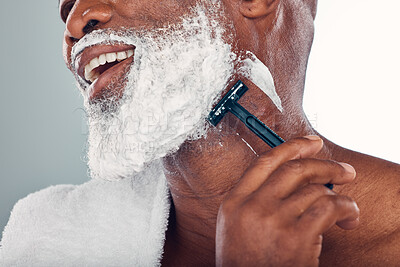 Buy stock photo Black man shaving, face and cream with razor, healthy skin with beauty and grooming isolated on studio background. Facial hair removal, happy elderly person and hygiene with skincare and wellness