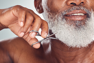 Buy stock photo Black man face, beard with scissors and beauty with grooming and hygiene, shaving zoom isolated on studio background. Senior person skincare, dermatology and body hair removal, hand and clean nails