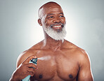 Old man, spray body with skin and smile for beauty, grooming and hygiene isolated on studio background. Happiness, wellness and skincare, cosmetic product and topless with perfume and fragrance