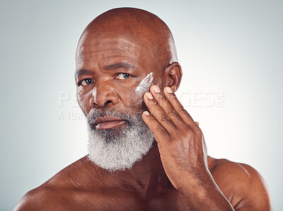 Buy stock photo Face cream, skincare and senior man in studio for wellness, beauty and grooming against grey background. Facial, skin and elderly model relax with luxury, cosmetics and wrinkle product while isolated