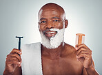 Black man, portrait smile and beard for shaving with razor, cream and comb for skincare, grooming or self care on a gray studio background. Happy African American male with shave kit for clean facial