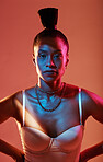 Portrait, neon and style with a model black woman in studio on a kaleidoscope background for beauty. Art, makeup and fashion with an attractive young female posing indoor for culture or cosmetics