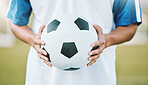 Hands, ball and soccer player ready for sports match, game or competition on the outdoor field. Hand holding round sphere object for sport, training or practice in physical activity outside in nature