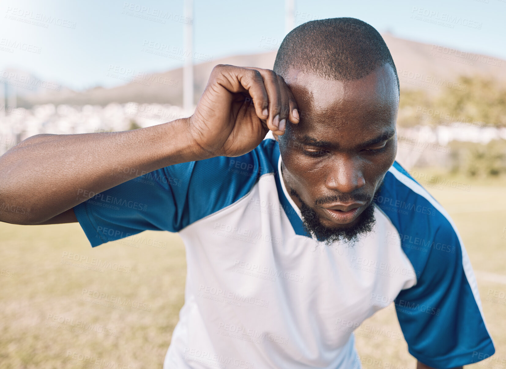 Buy stock photo Black man is tired, face and football player on outdoor field, playing game or soccer training with energy and exhausted athlete. Team sport, sweating and fitness, challenge and fatigue with workout